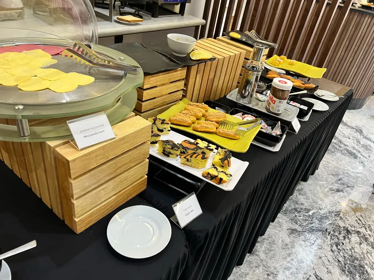Buffet breakfast spread with pastries and cheeses
