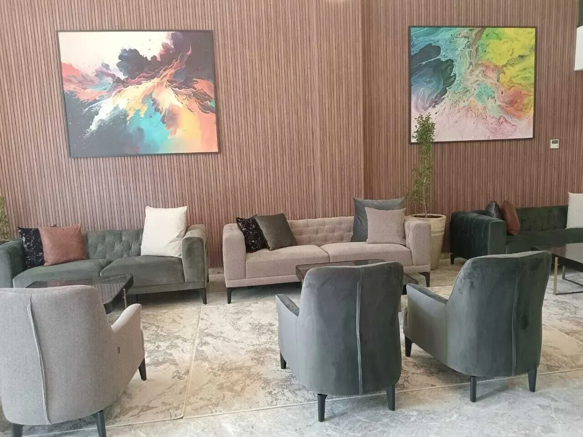 Lobby seating area with armchairs and marble flooring